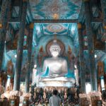 peron praying at buddha for good luck