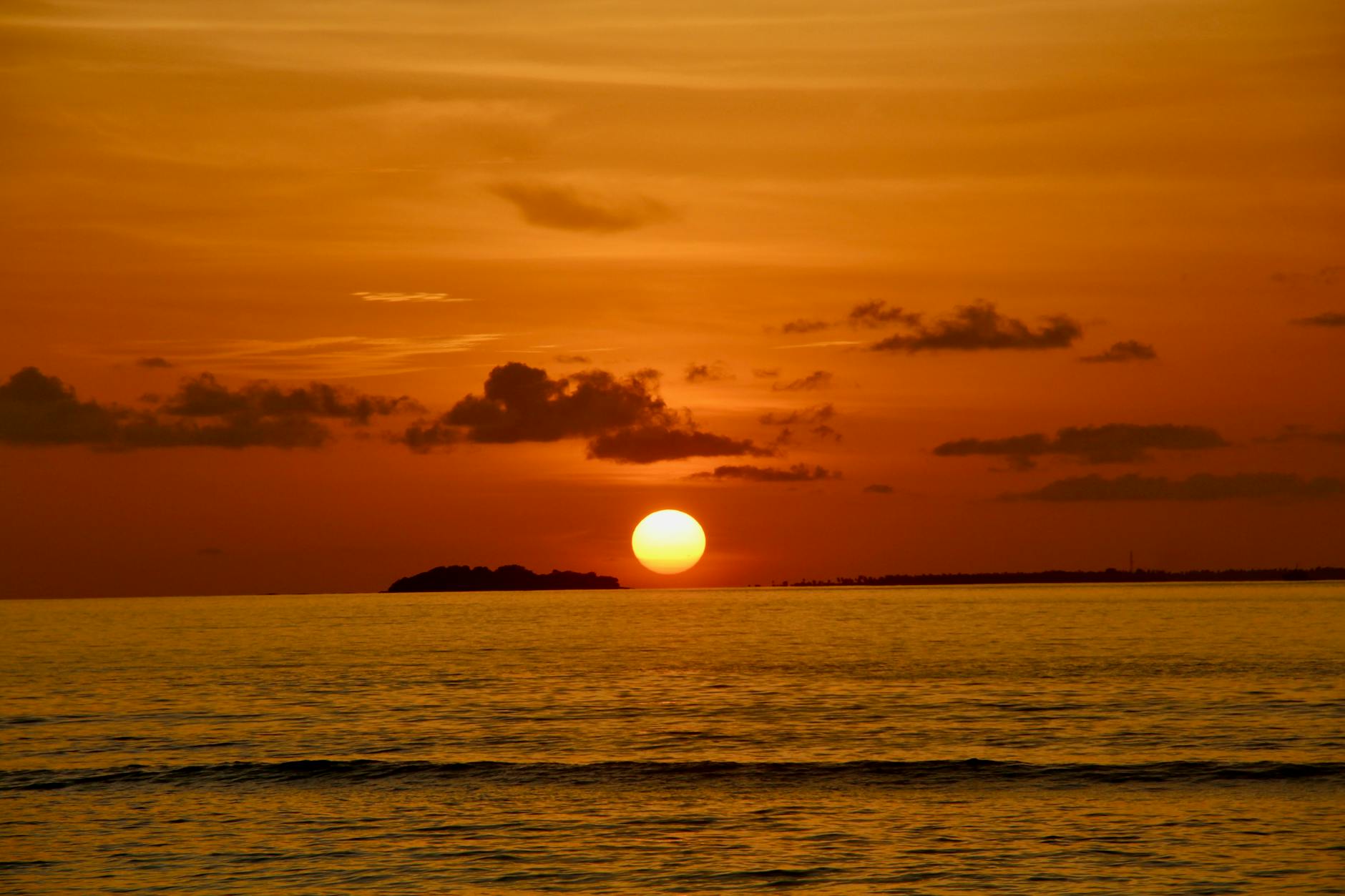 serene ocean sunset with orange sky